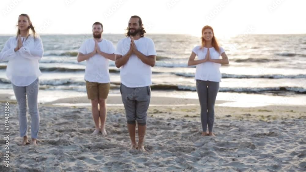 group of people making yoga exercises on beach group of people making yoga exercises on beach