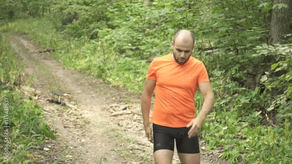Man running cross country in summer forest. Jogging motivation in green park beautiful inspirational landscape Slow Motion. Man running cross country in summer forest. Jogging motivation in green park beautiful inspirational landscape Slow Motion.