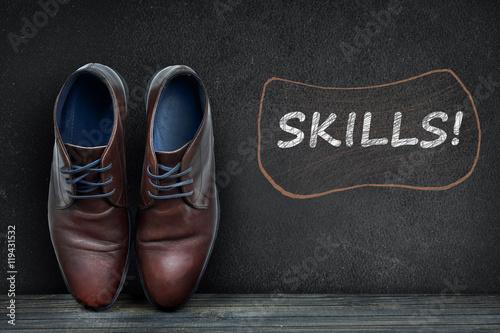 Skills text on black board and business shoes