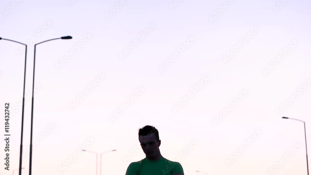 Runner man stretching and taking rest on road. Handsome Caucasian male fitness model outdoors. Runner man stretching and taking rest on road. Handsome Caucasian male fitness model outdoors.