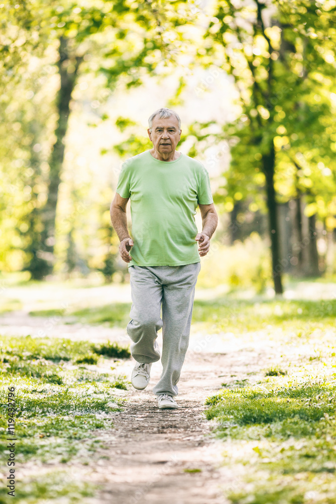 Senior man is jogging in park. Active retirement. Senior man is jogging in park. Active retirement.