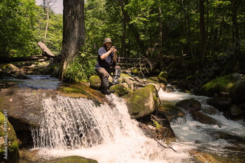 Tourist photographs the camera river landscape photo