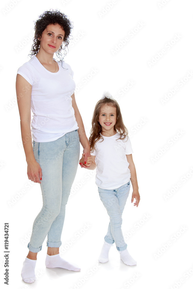 Mom and daughter in jeans white shirts Mom and daughter in jeans white shirts