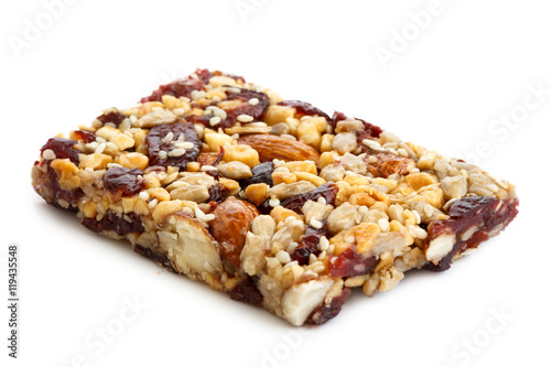 Fruit, nut and seed bar with cranberries isolated on white.