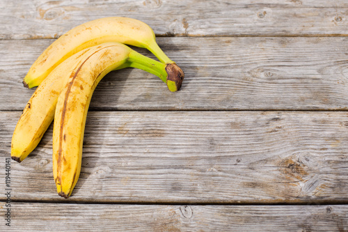 Banana on wooden background. Place for text.