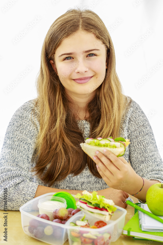 Young girl with healthy food in a lunch box. Back to school. Young girl with healthy food in a lunch box. Back to school.