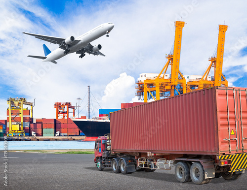 Truck transport container and cago plane flying above ship port photo