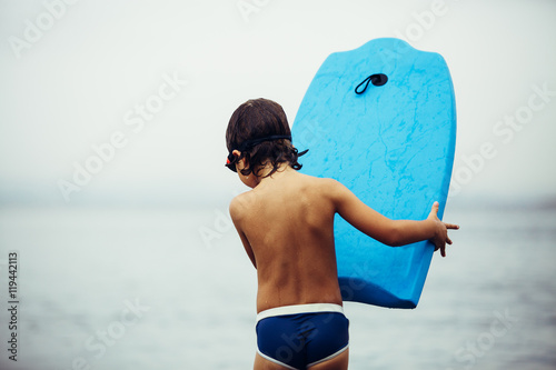 back view of kid with bodyboard photo