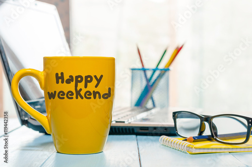 Happy Weekend coffee cup at office background or student workplace. E-learning, self-education concept photo