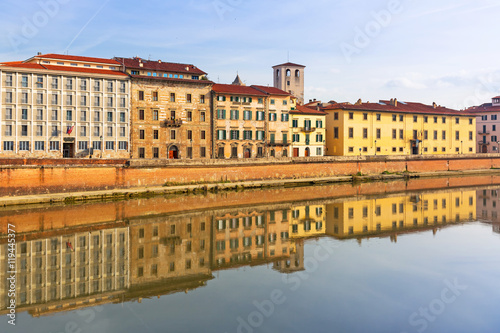 Old town of Pisa with reflection in Arno river, Italy