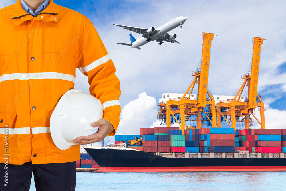Engineer wearing safety coat and holding a helmet in port Engineer wearing safety coat and holding a helmet in port