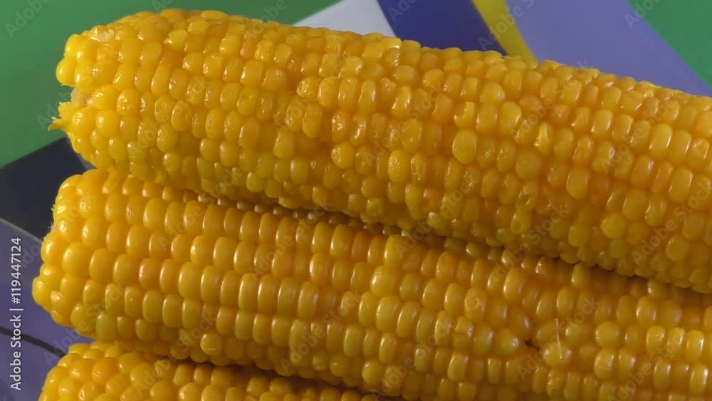 Boiled juicy corn on the dinner table Boiled juicy corn on the dinner table