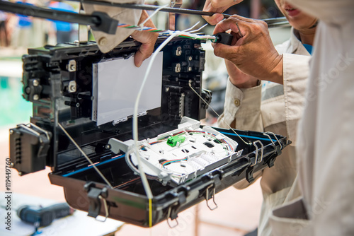 Technicians are install cabinet on fiber optic cable.Blur images