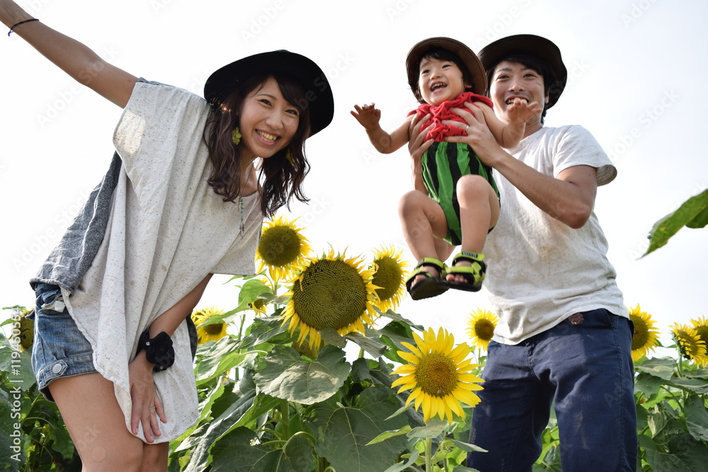 young family is smiling with sunflower field Stock-Foto | Adobe Stock