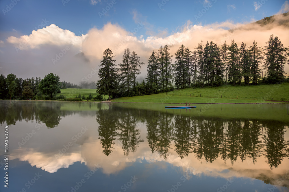 Fototapeta premium Foggy Morning on lake, with beautiful clouds and reflection