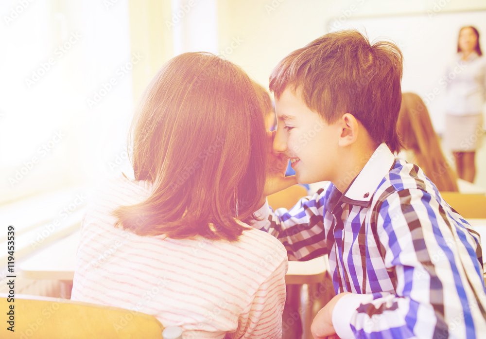 smiling schoolgirl whispering to classmate ear smiling schoolgirl whispering to classmate ear