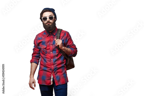 Bearded tourist. Handsome young man carrying backpack