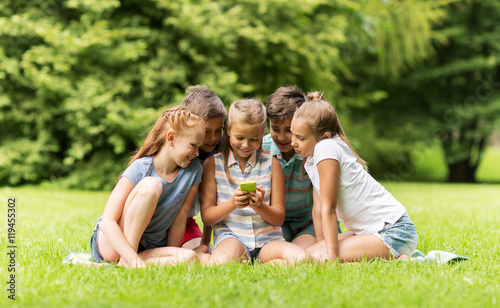 kids or friends with smartphone in summer park