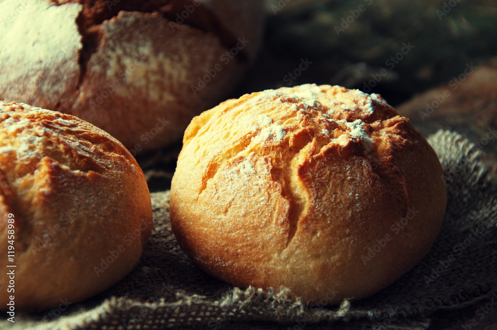 Bread and rolls on a wooden background