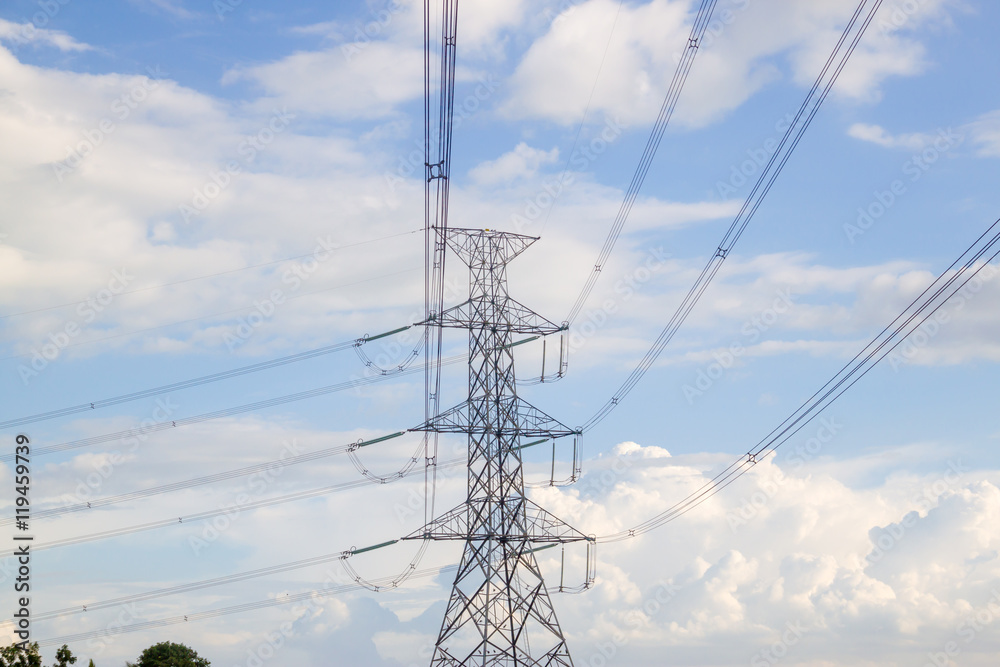 Electricity pylon silhouetted against blue sky wih cloud background. High voltage tower Electricity pylon silhouetted against blue sky wih cloud background. High voltage tower