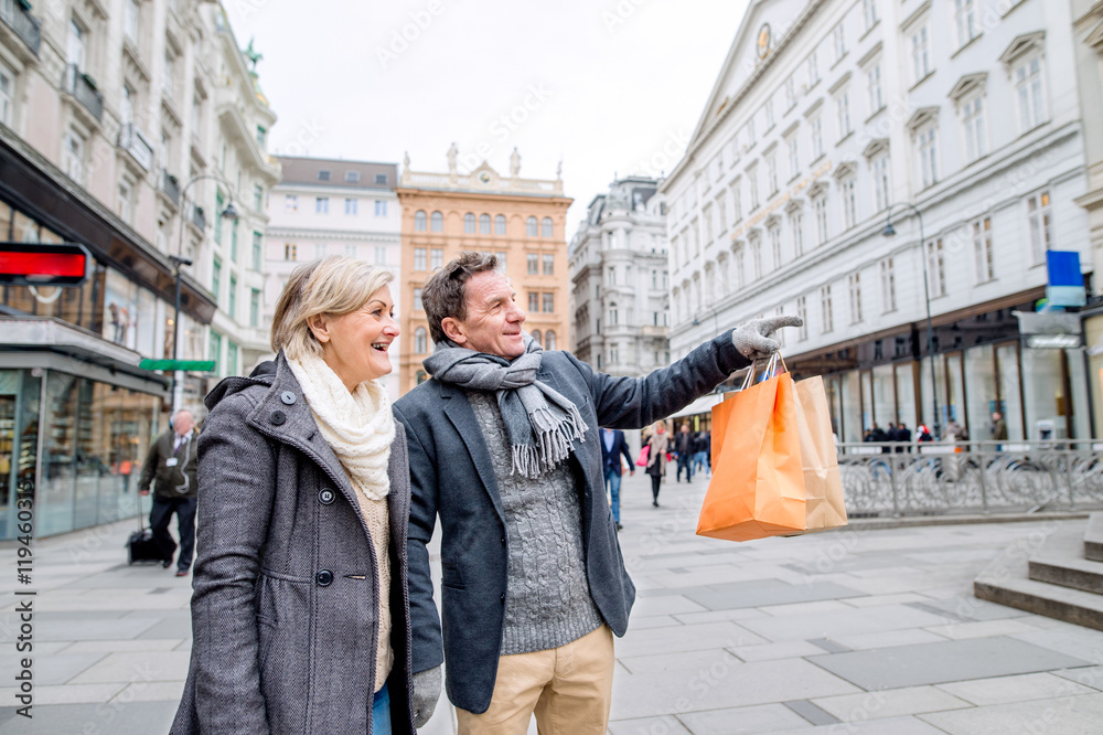 Senior couple shopping in centre of the city. Winter