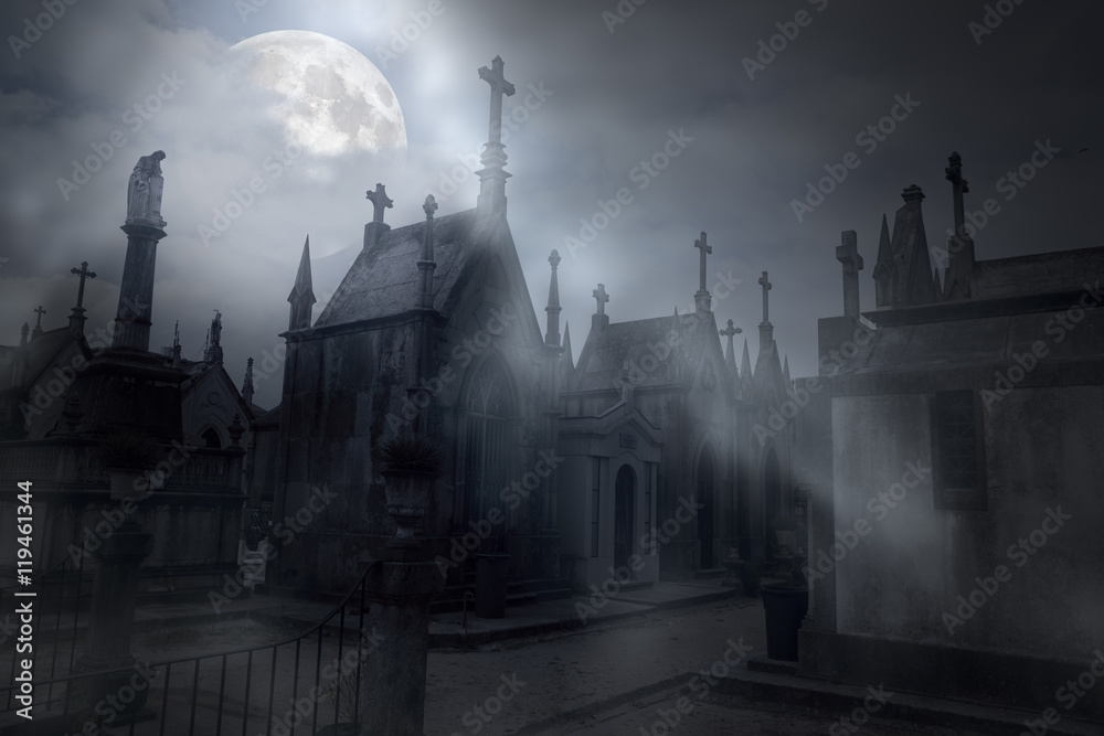 Cemetery in a foggy full moon night