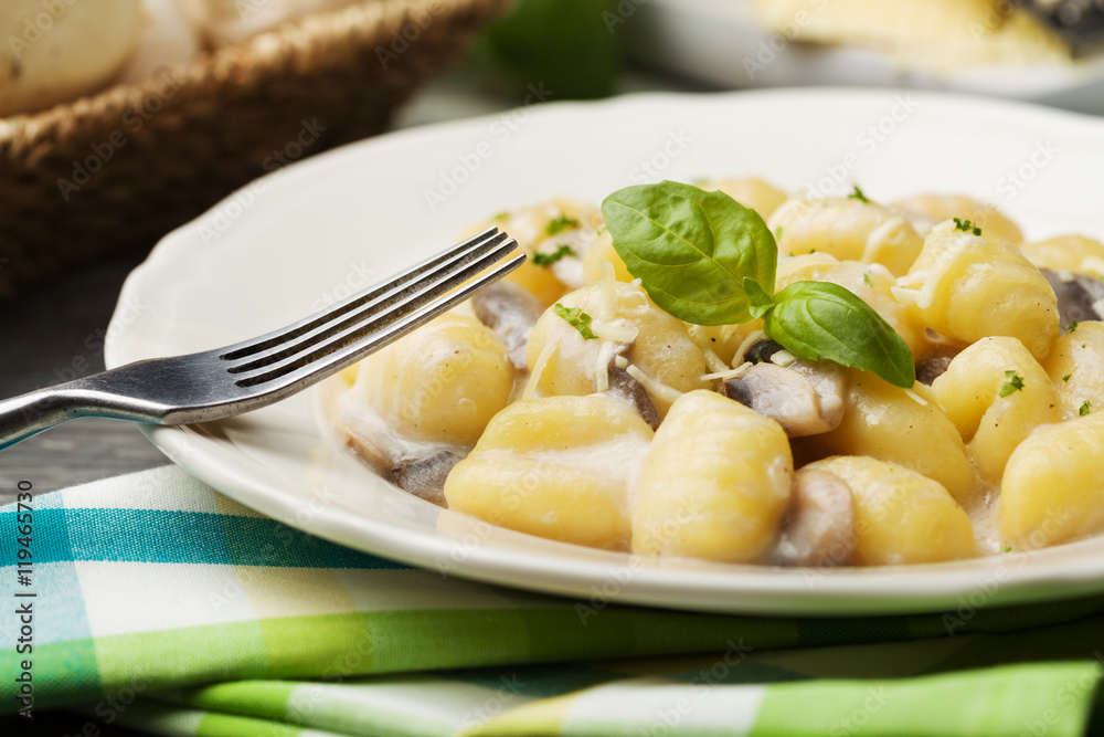 Portion of gnocchi with mushroom sauce and cheese. Portion of gnocchi with mushroom sauce and cheese.