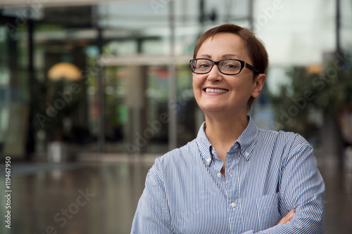 Older  business woman portrait. Professional headshot of businesswoman in the office. Middle-aged female 40 50 years old wearing glasses. Portrait of manager, teacher., principal, customer service