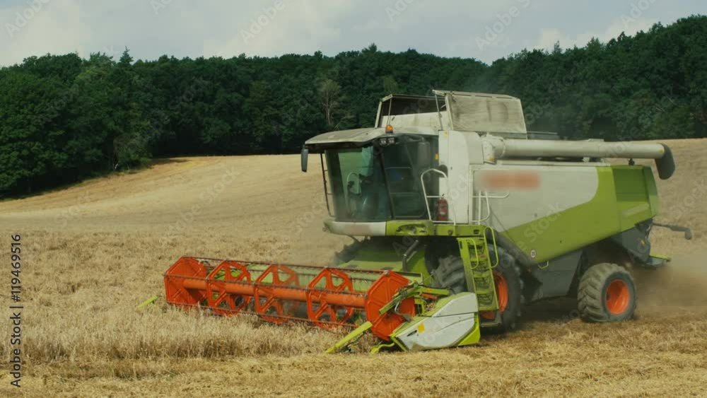 Combine Harvester working on Wheat Field Combine Harvester working on Wheat Field