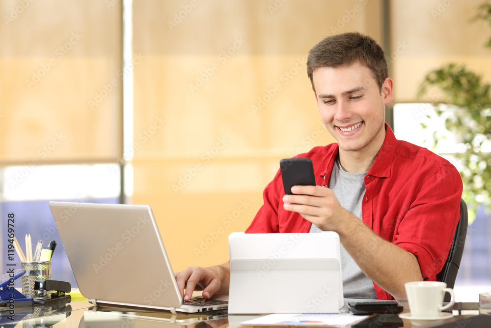 Businessman working with multiple devices Businessman working with multiple devices