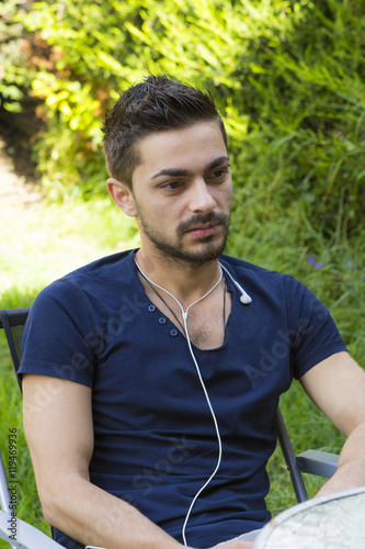 Fototapeta Naklejka Na Ścianę i Meble -  Young man with earphones outdoors