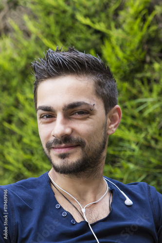 Young man with earphones outdoors