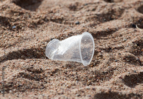 plastic cup on the sand