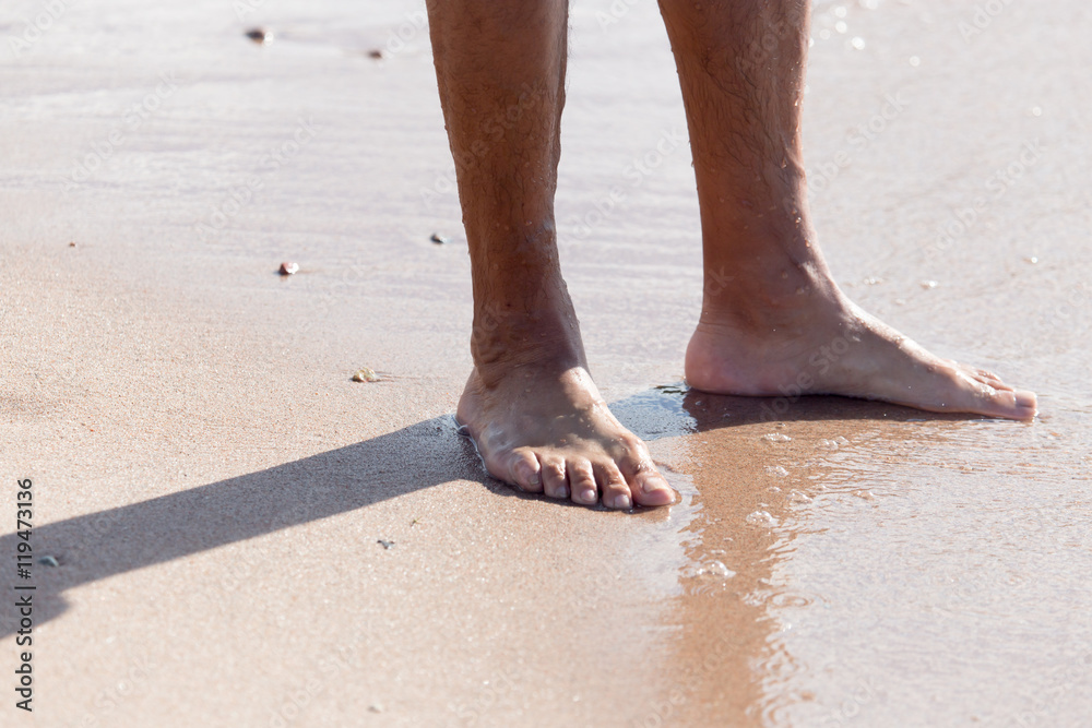Men's legs on the beach Men's legs on the beach