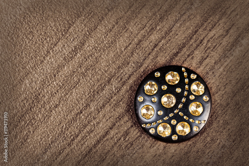 Black buttons with rhinestones on the wooden background