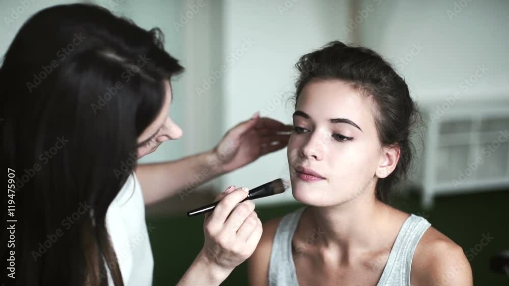 a makeup artist prepares a model to shoot a makeup artist prepares a model to shoot