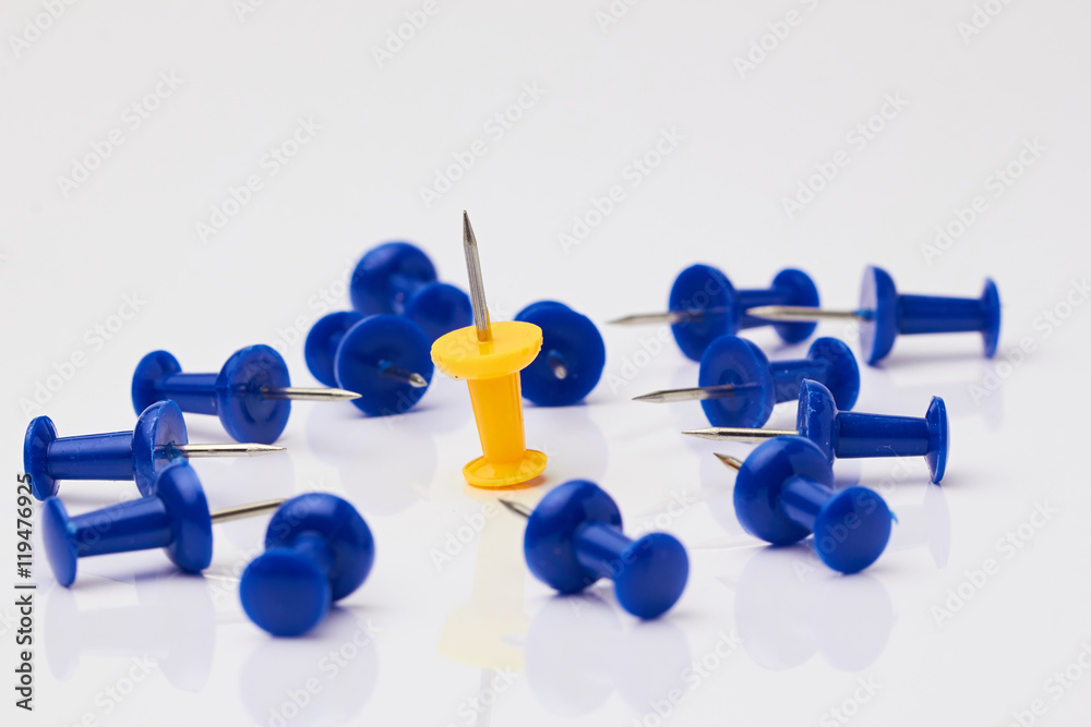 Blue and yellow thumbtacks on a white background./Blue and yellow thumbtacks on a white background. Blue and yellow thumbtacks on a white background./Blue and yellow thumbtacks on a white background.