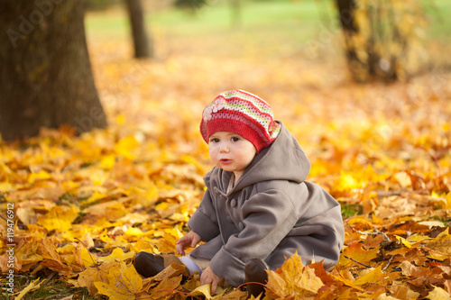 Small girl in autumn park