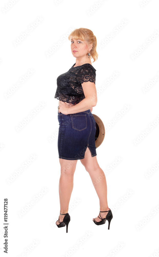 Fototapeta premium Tall blond woman holding a hat.