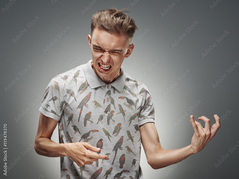 Emotional portrait of a teenager on a gray background Emotional portrait of a teenager on a gray background