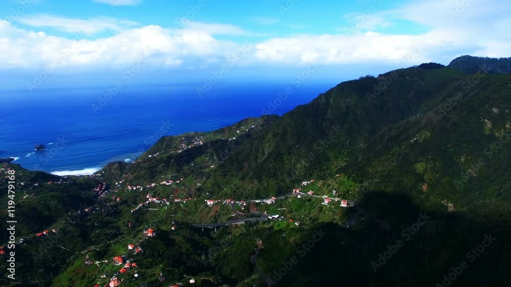 Aerial view of ocean sea coast. Portugal Madeira village landscape 4k travel video background. Flight over forest hills, houses, blue sky Aerial view of ocean sea coast. Portugal Madeira village landscape 4k travel video background. Flight over forest hills, houses, blue sky