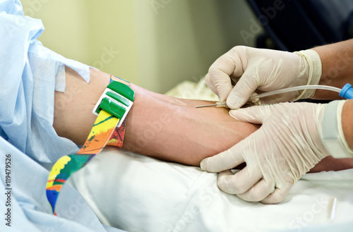 Inserting a needle into a vein hands for blood sampling