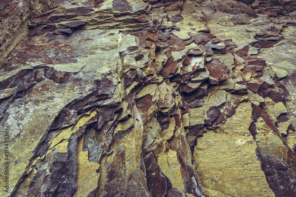 Ferruginous rock strata closeup. Rock layers background.