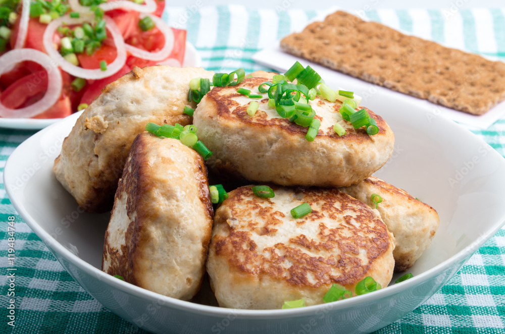 Homemade chicken burgers  and salad with fresh tomatoes