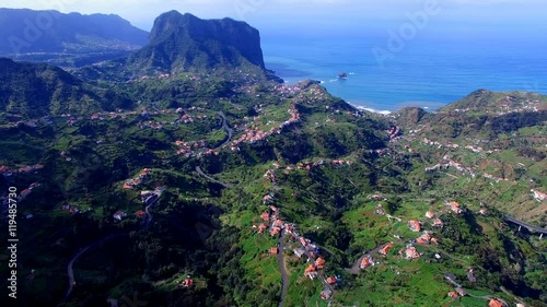 Portugal Madeira 4k travel aerial video background. Flight over mountain ravine city village, houses, forest hills and blue sky.