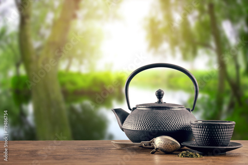 Black tea set on wooden table and blurred nature background