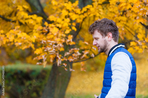 man relaxing walking in autumn park