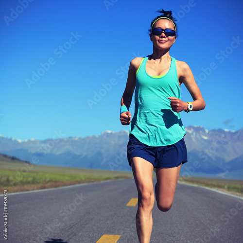 Fototapeta Naklejka Na Ścianę i Meble -  young fitness healthy lifestyle woman runner running on road