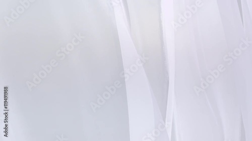 Sheer white curtains blowing in the wind
