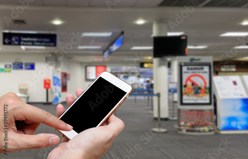 Human holding blank screen of smart phone and waiting departures